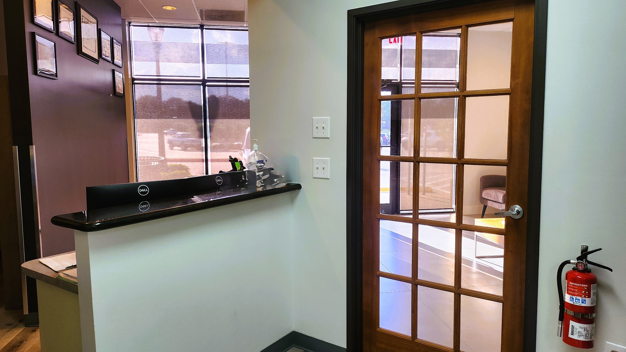 Grey walls with black baseboards and wood-look vinyl flooring.